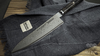 Damasceński nóż Gyuto Miyabi 5000 MCD BLACK 67 na tkaninie