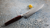 Ko-Santoku Mcusta Zanmai Revolution na dekoracyjnym tle z różą i perełkami.