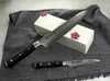 Nóż Mcusta Zanmai Gyuto Classic Pro Zebra na tle szarej tkaniny