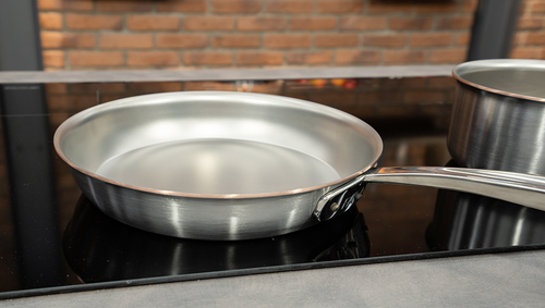 Patelnia Copper Core Falk na kuchence, stalowo-miedziana, Ø 32 cm, gotowa do serwowania.