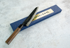 Japoński nóż Gyuto 21 cm Sakai Takayuki Iron Kurouchi na tle eleganckiego opakowania.