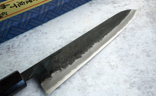 Japoński nóż Gyuto 24 cm Sakai Takayuki Iron Kurouchi na tle marmuru.