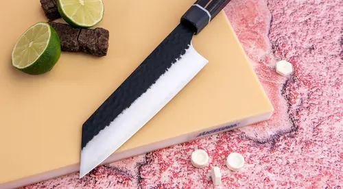 Japoński nóż Bunka Suncraft Senzo Finest na tle kolorowej deski.