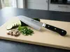 Profesjonalny japoński nóż Santoku Suncraft Senzo Professional SG2 na desce z warzywami w kuchni